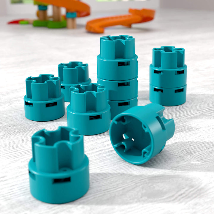 Teal plastic risers on a light wooden surface with blurred track set in the  background
