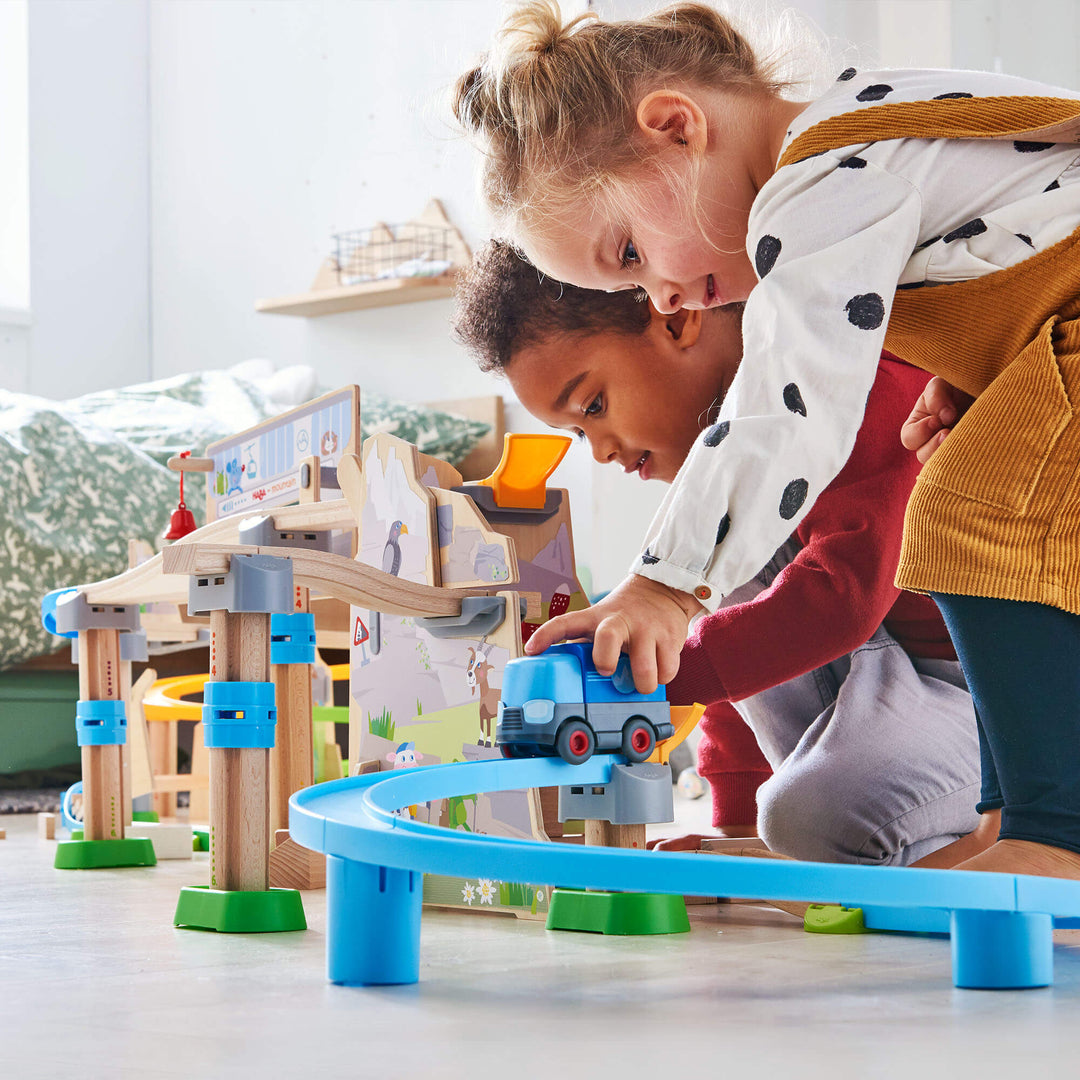 Two kids playing with Kullerbu Mountain Adventure Track Set in bedroom