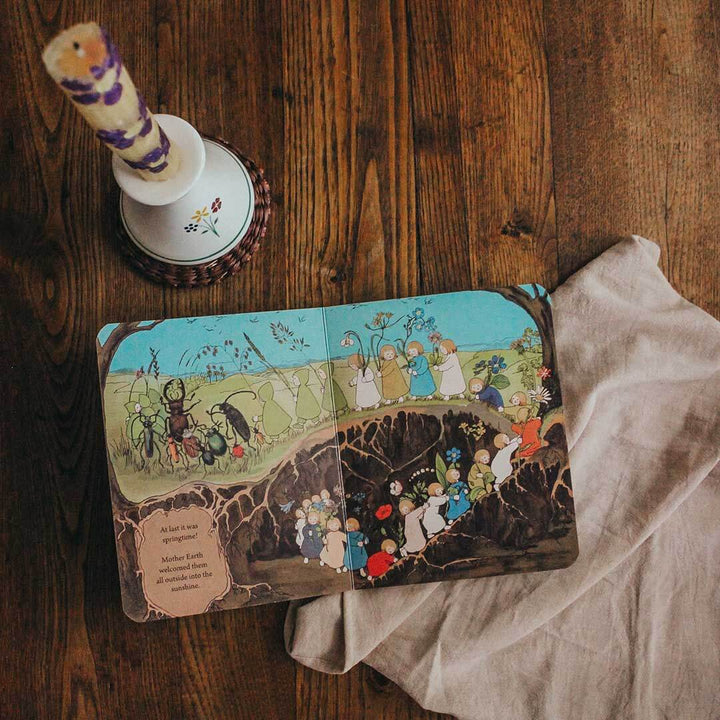 Open book with colorful illustrations on a wooden surface