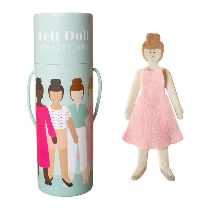 Lowercase Toys Felt doll with light skin tone shown  wearing a pink dress, with the package next to her on a white backround.
