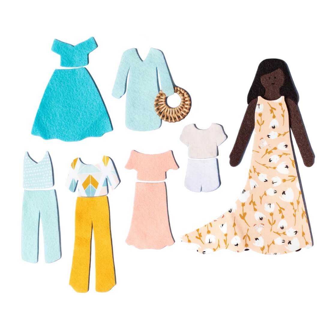 Lowercase Toys felt doll with floral dress, clothing pieces, and pink Felt Doll Set package arranged on white background.
