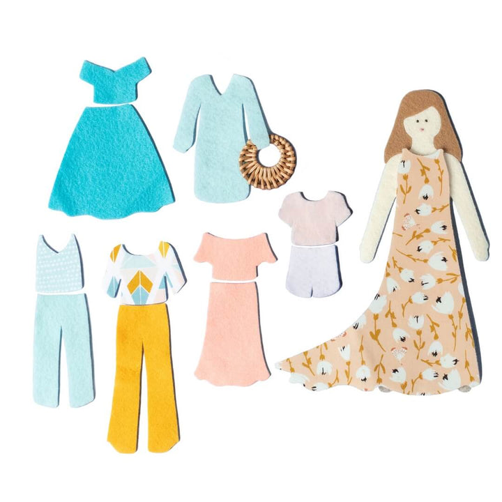 Lowercase Toys felt doll with floral dress, clothing pieces, and pink Felt Doll Set package arranged on white background.
