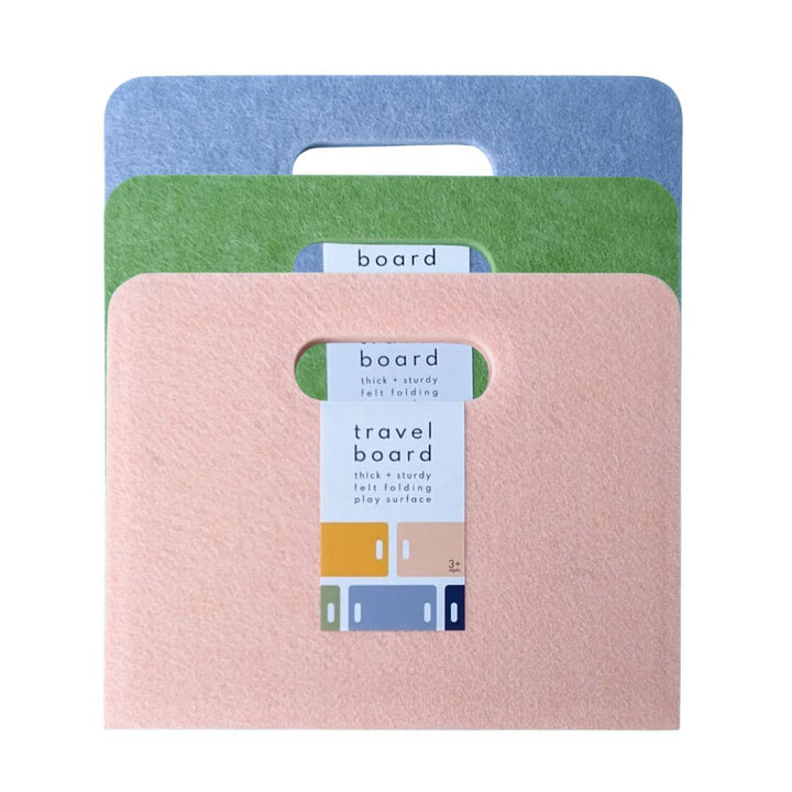 Set of three Felt Travel Play Boards from Lowercase Toys in peach, pear, and periwinkle stacked together with packaging label on front.