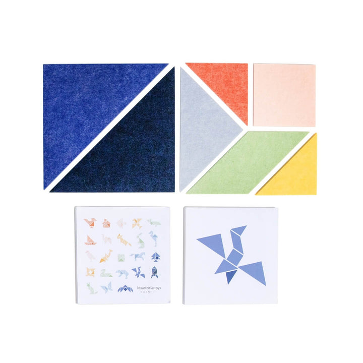 Colorful felt Tangram puzzle pieces from Lowercase Toys arranged on a white background, showing the full 7-piece set.