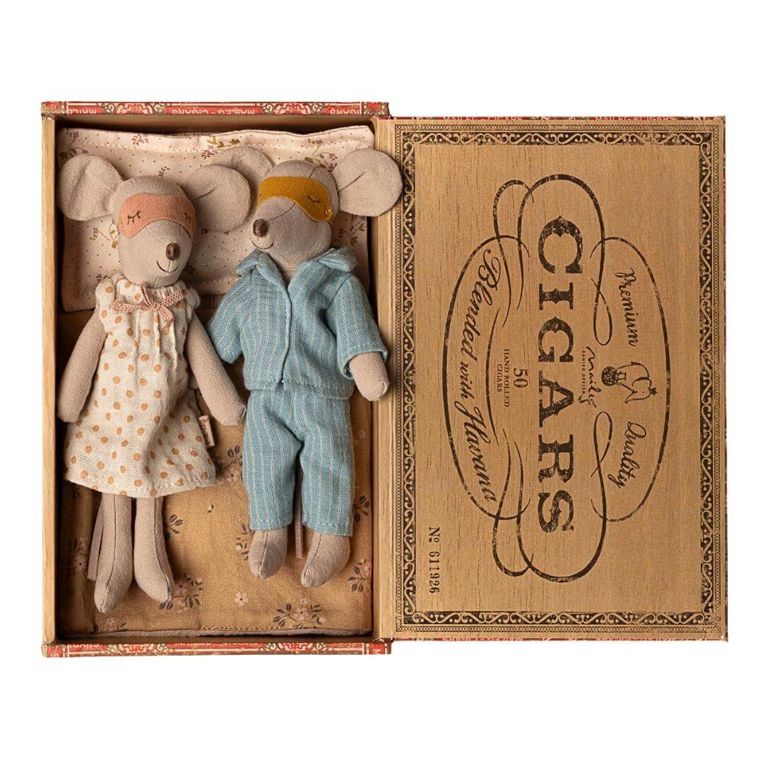 Maileg Mom and Dad Mouse with sleep masks on in vintage-style cigar box bed with pajamas and blanket, from Bella Luna Toys.