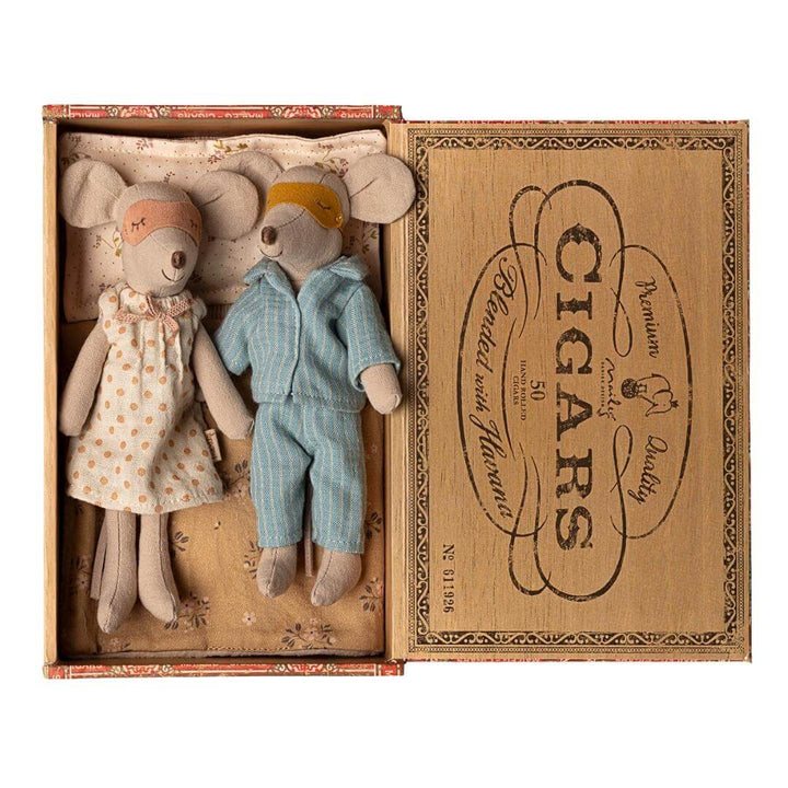 Maileg Mom and Dad Mouse with sleep masks on in vintage-style cigar box bed with pajamas and blanket, from Bella Luna Toys.