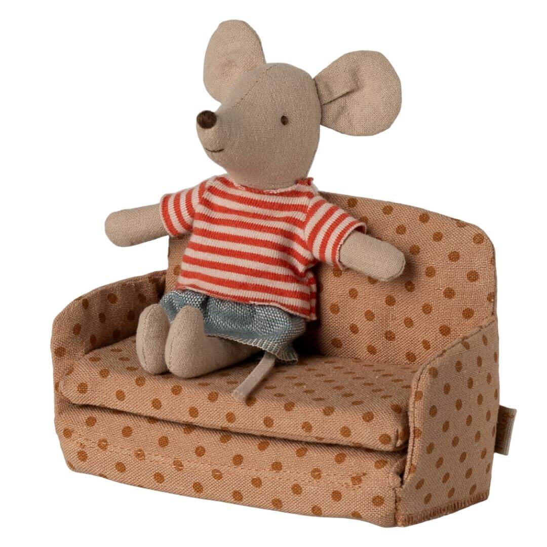 Maileg mouse-sized sofa bed in polka dot fabric, with a mouse in a striped shirt and skirt sitting on it from Bella Luna Toys.