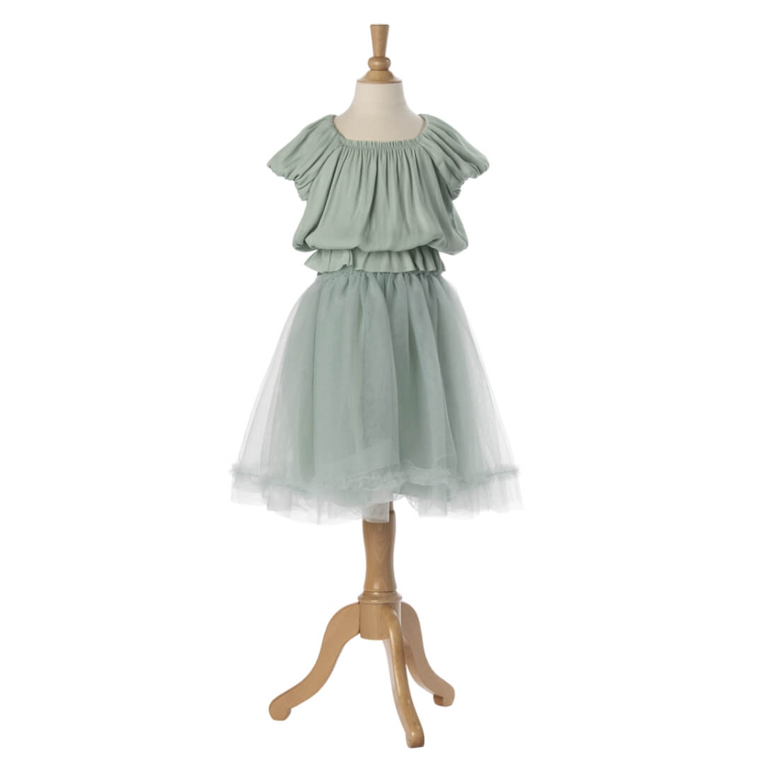 Light green dress on a mannequin against a white background