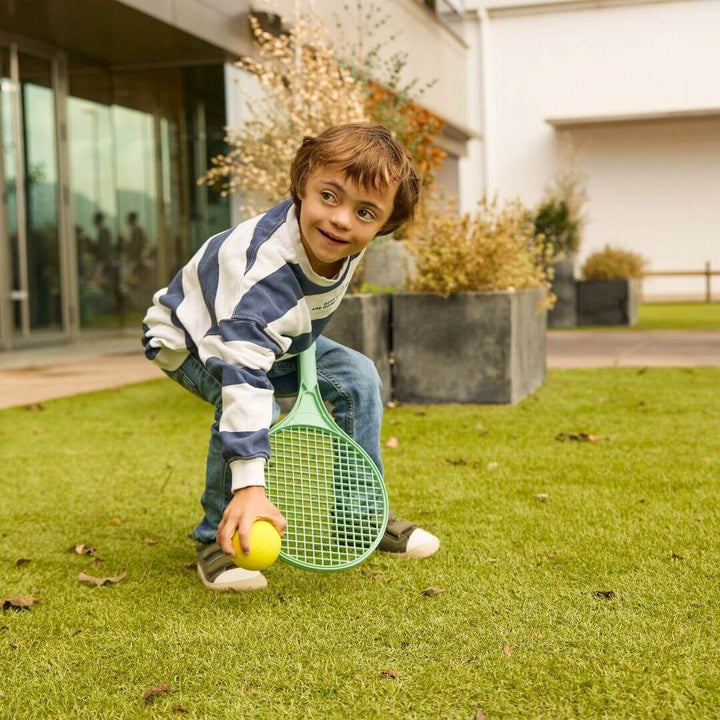 A child playing with the Miniland Eco Racket and Ball Set