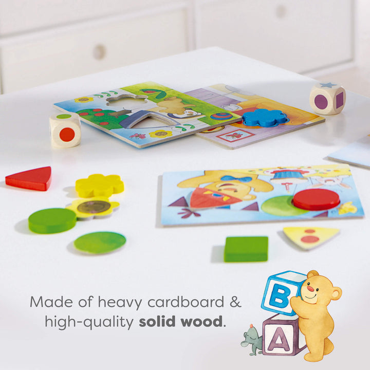 Colorful educational puzzles on a white surface. Text reads "Made of heavy cardboard & high-quality solid wood."