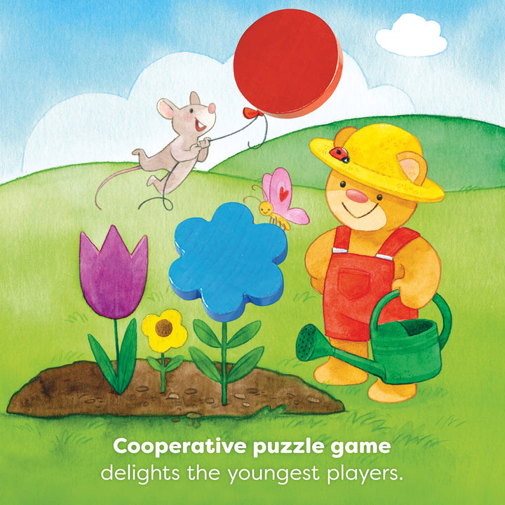 Illustration of a bear in overalls with a watering can, a mouse with a balloon, flowers, and a butterfly on a grassy field. Text reads "Cooperative puzzle game delights the youngest players."
