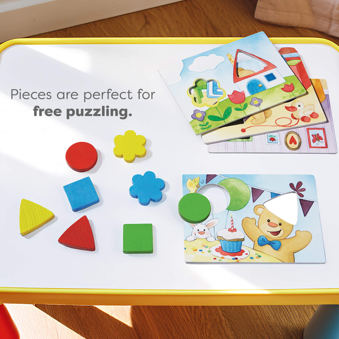 Colorful geometric puzzle pieces and templates on a yellow-bordered table.Text reads "Pieces are perfect for free puzzling."