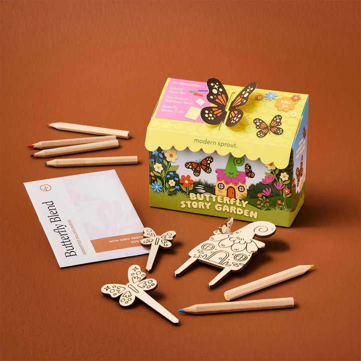 Butterfly-themed story garden set with wooden butterflies, pencils, and a card on a brown background.