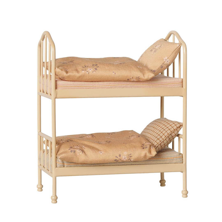 A miniature two-tier wooden bunk bed with floral-patterned beige bedding and pillows, shown against a plain white background.