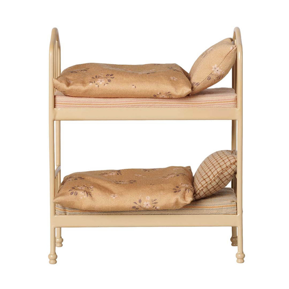 A two-tier dollhouse metal bunk bed frame with floral-patterned tan bedding and pillows, shown against a plain white background.