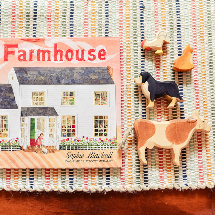 The Farmhouse Book on a multicolored carpet.