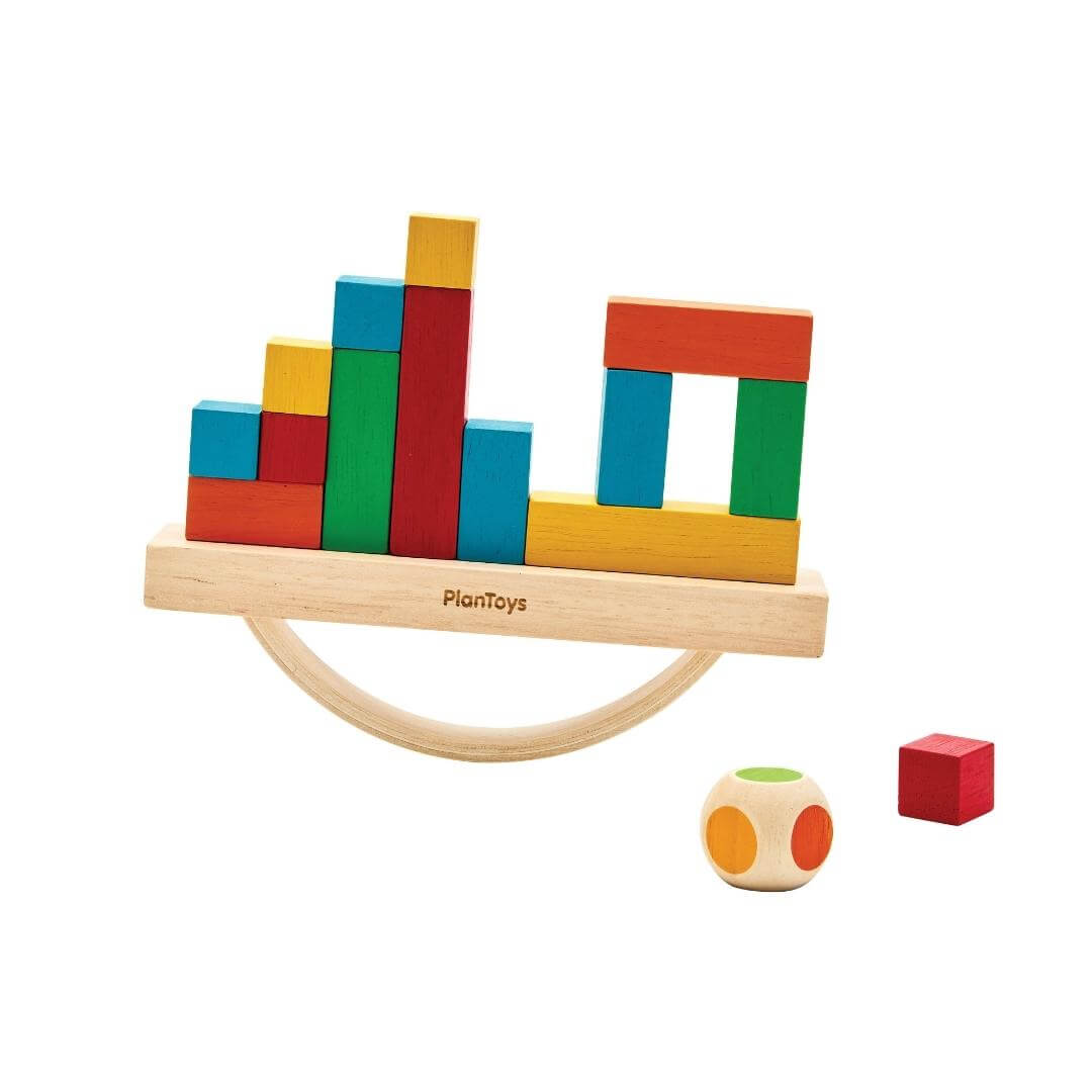 PlanToys Montessori Balancing Cargo Set with rocking wooden boat, colorful blocks stacked on top, and a color-die included.