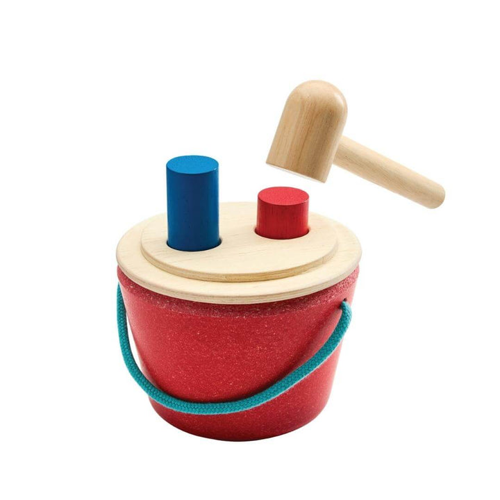 PlanToys Hammering Peg Bucket with wooden mallet and colorful red and blue pegs for Montessori-inspired play.
