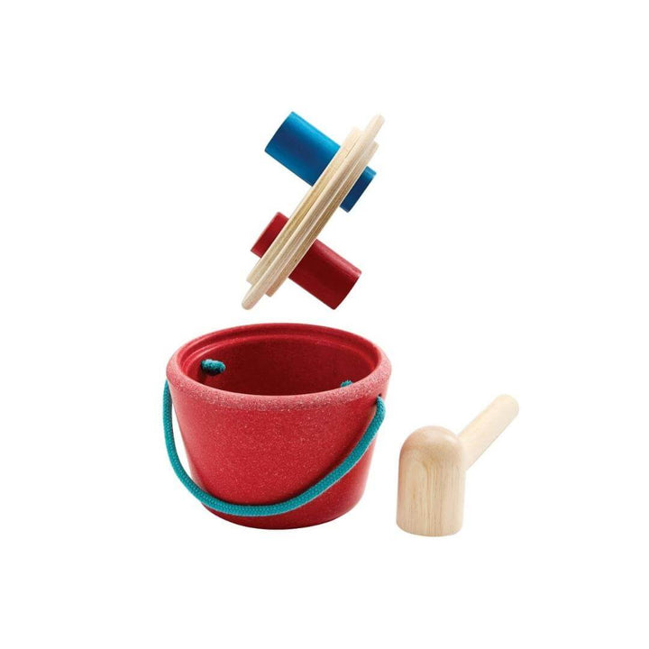 PlanToys Hammering Peg Bucket with wooden mallet and colorful red and blue pegs for Montessori-inspired play shown with the lid off and the hammer resting on a white surface.