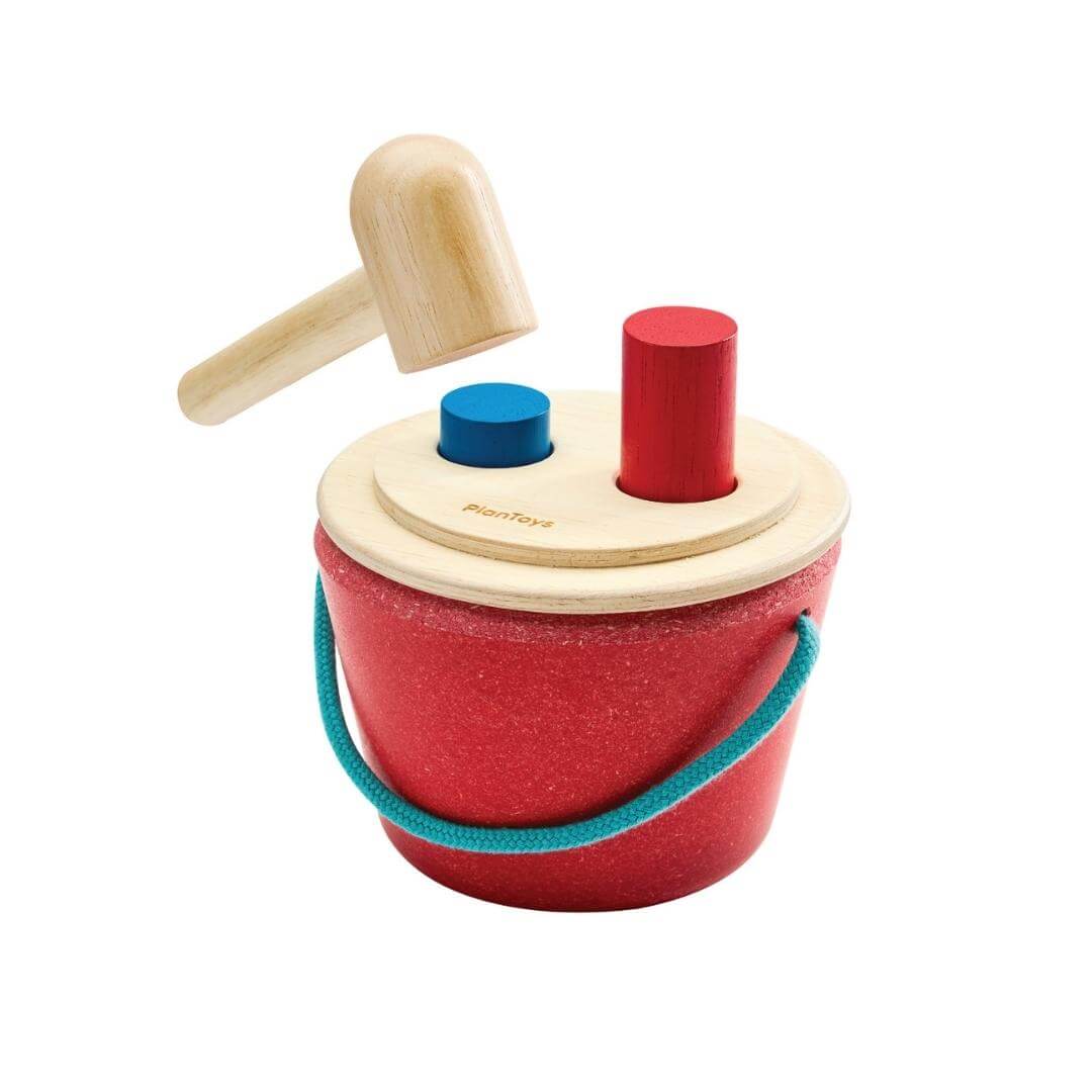 PlanToys Hammering Peg Bucket with wooden mallet and colorful red and blue pegs for Montessori-inspired play.