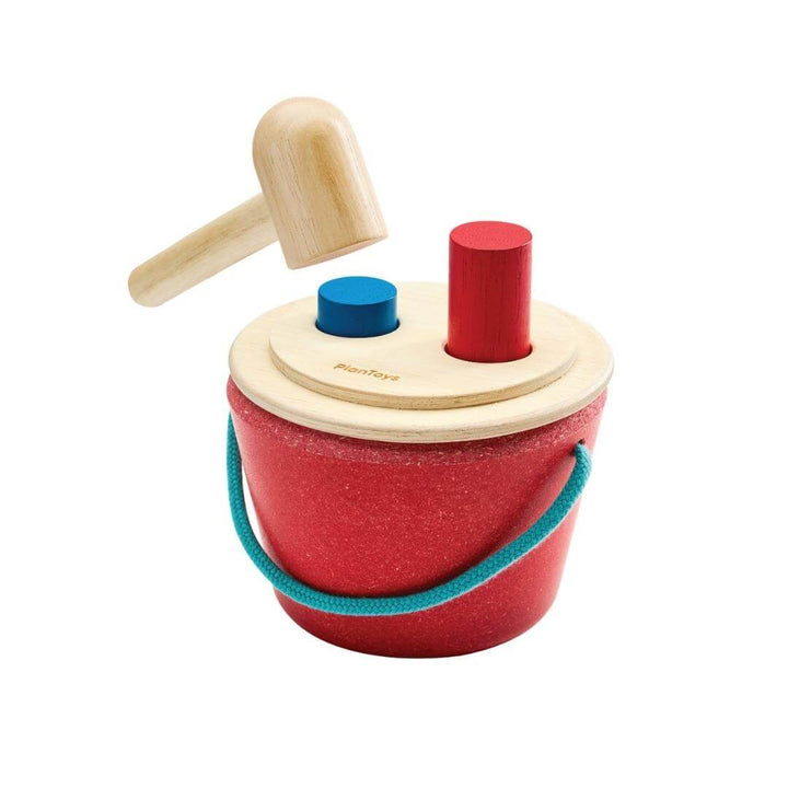 PlanToys Hammering Peg Bucket with wooden mallet and colorful red and blue pegs for Montessori-inspired play.