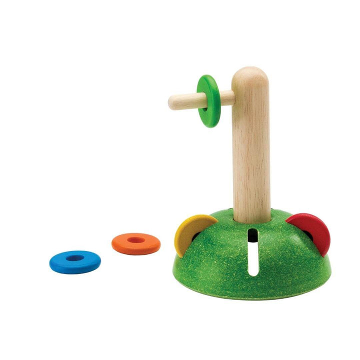 PlanToys Horizontal Stacking Set with colorful wooden discs on a vertical post and green base.
