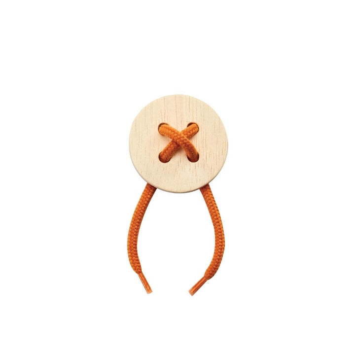 Smaller 4 hole round wooden lacing board with orange string threaded in a crisscross pattern.