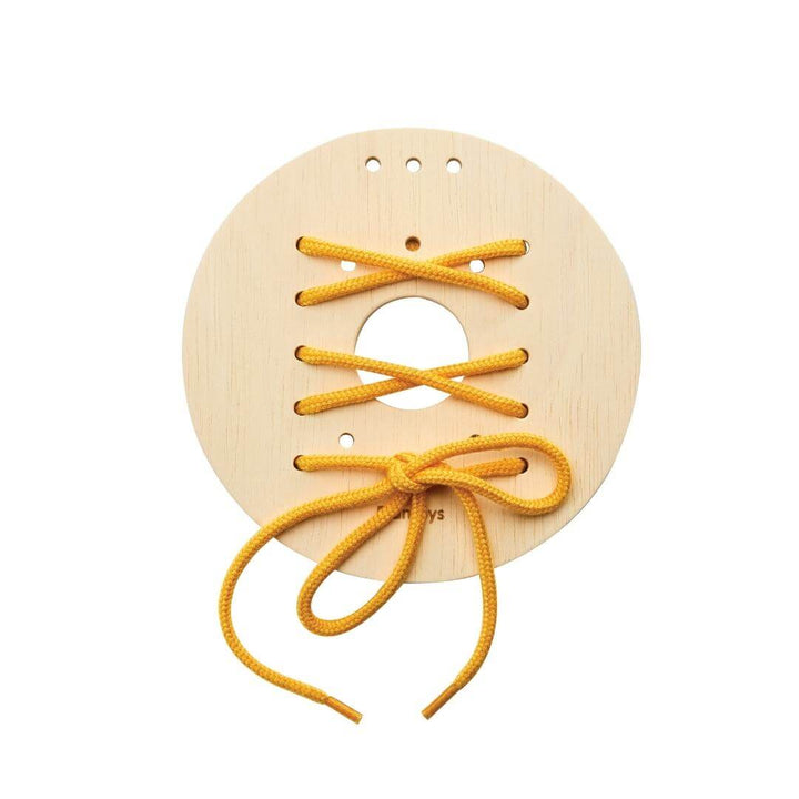 Round wooden lacing board with yellow string threaded in a crisscross pattern and tied in a bow at the bottom.