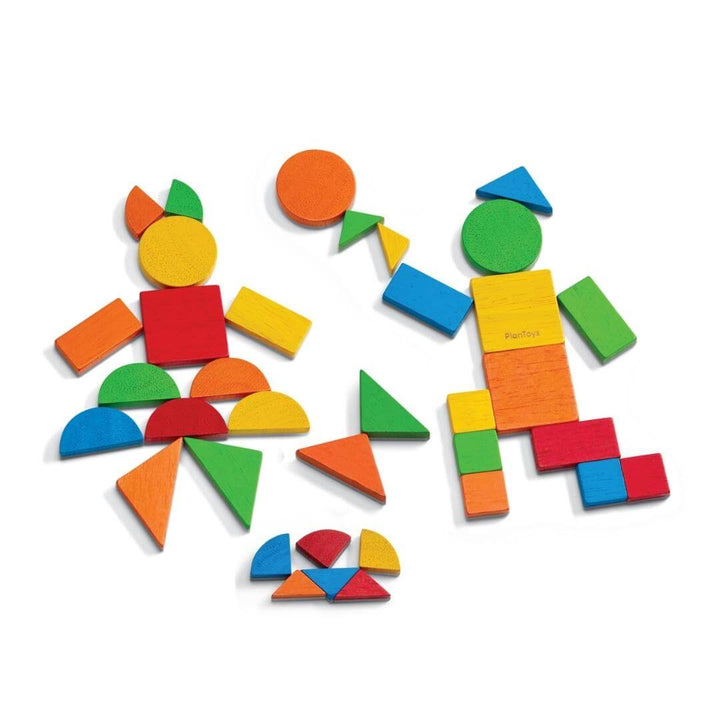 PlanToys Montessori Mosaic Shape Set showing colorful geometric tiles arranged into shapes and patterns of people on a white background.