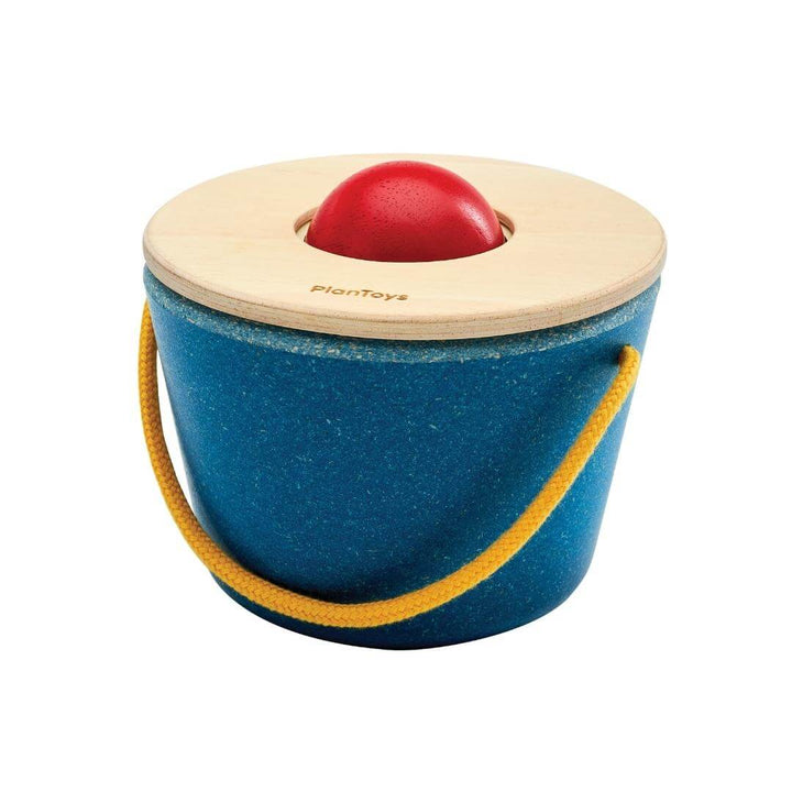 PlanToys Montessori Pop n Drop Bucket in blue with yellow handle, featuring a red wooden ball on top, designed for Montessori cause-and-effect play.