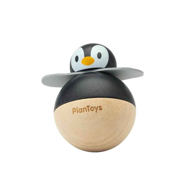 PlanToys Montessori Rolly Penguin wobbling toy made from rubberwood, with a high-contrast black-and-white design and rounded base for rocking movement.