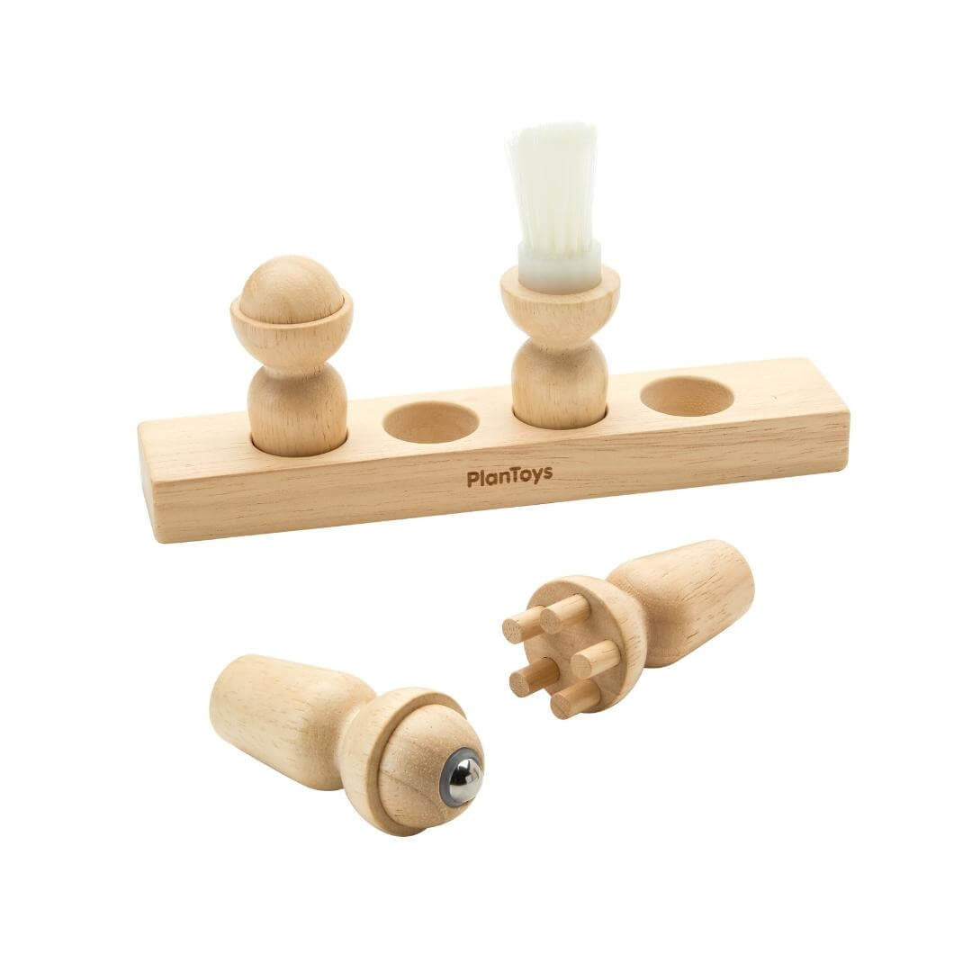 PlanToys Montessori Sensory Explorer Set with four wooden cylinders on a base, each featuring a unique tactile texture for sensory play.