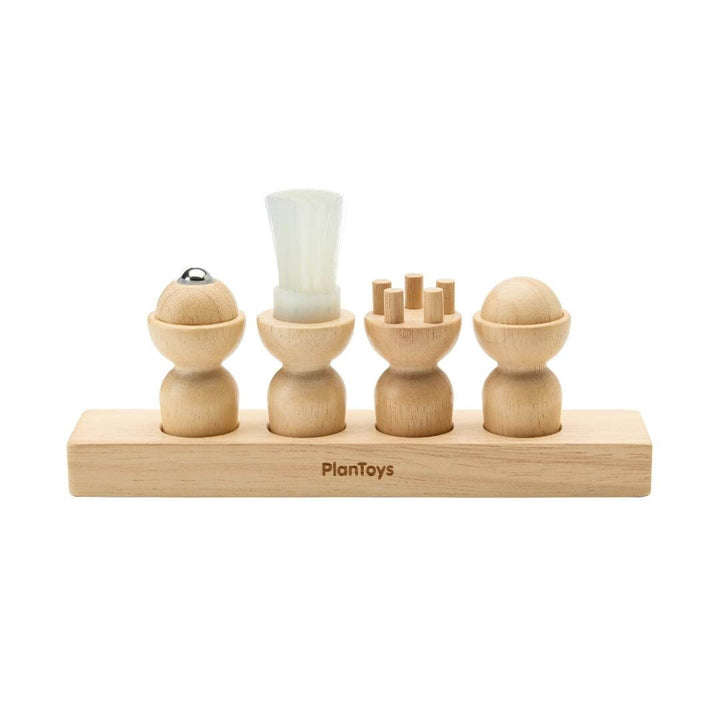 PlanToys Montessori Sensory Explorer Set with four wooden cylinders on a base, each featuring a unique tactile texture for sensory play.