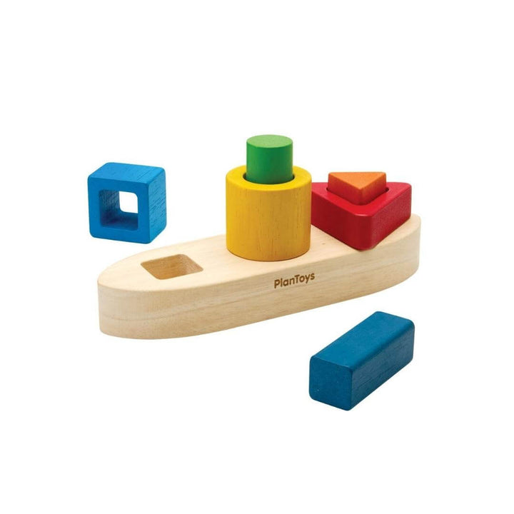 PlanToys Montessori Shape Sorting Boat Puzzle with natural wood boat base and colorful red, yellow, green, and blue geometric blocks for shape-sorting play.