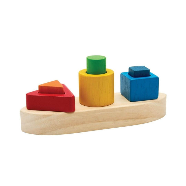 PlanToys Montessori Shape Sorting Boat Puzzle with natural wood boat base and colorful red, yellow, green, and blue geometric blocks for shape-sorting play.