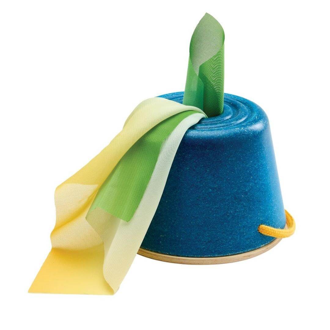 PlanToys Montessori Tissue Bucket with soft colorful cloths for babies to grasp and pull, designed to build fine motor skills and encourage independent play shown flipped over with the bottom hole filled with tissues.