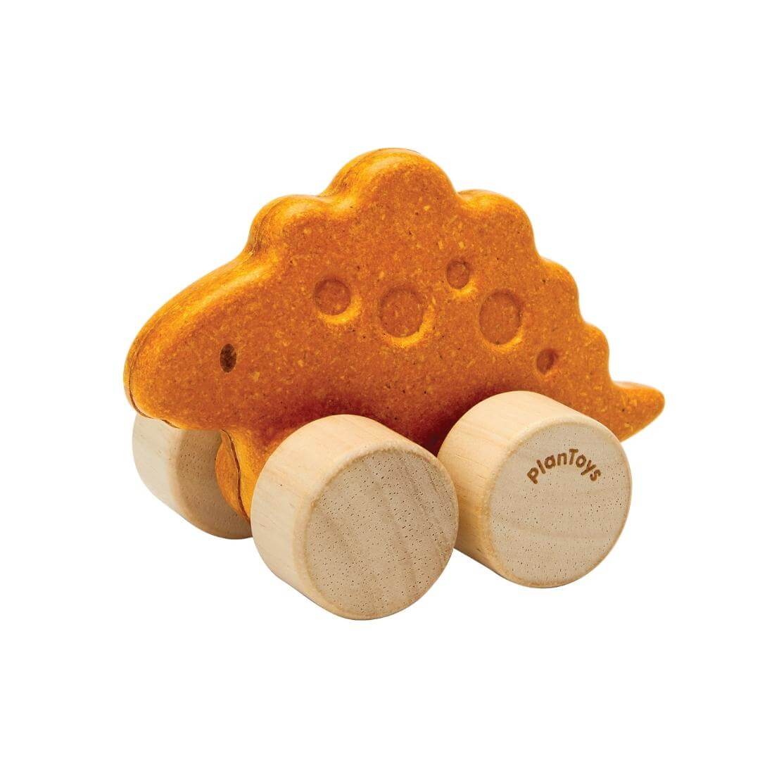 PlanToys Montessori Stego Car in orange, shaped like a stegosaurus with four natural wooden wheels, designed for toddlers to push and roll.