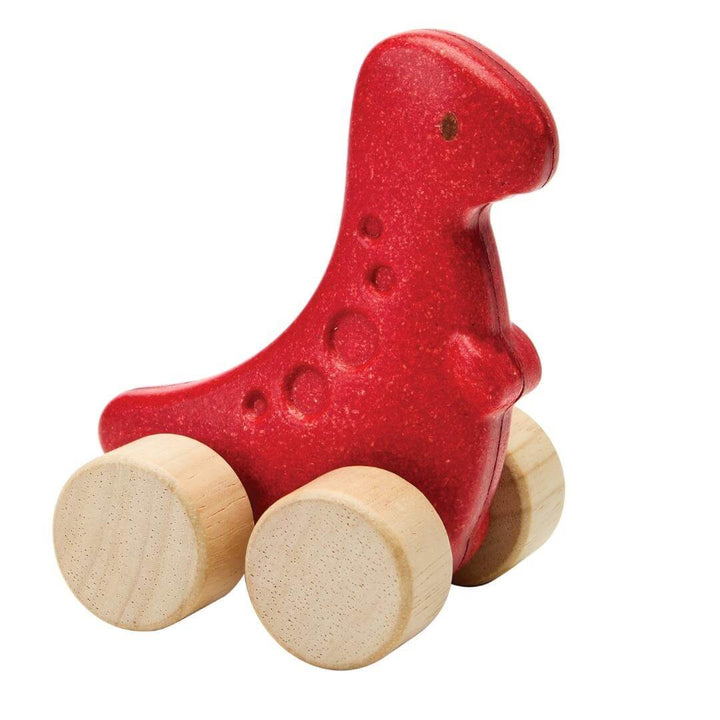 PlanToys Montessori Dino Rex Car in red, shaped like a T-Rex with four natural wooden wheels, designed for toddlers to push and roll.