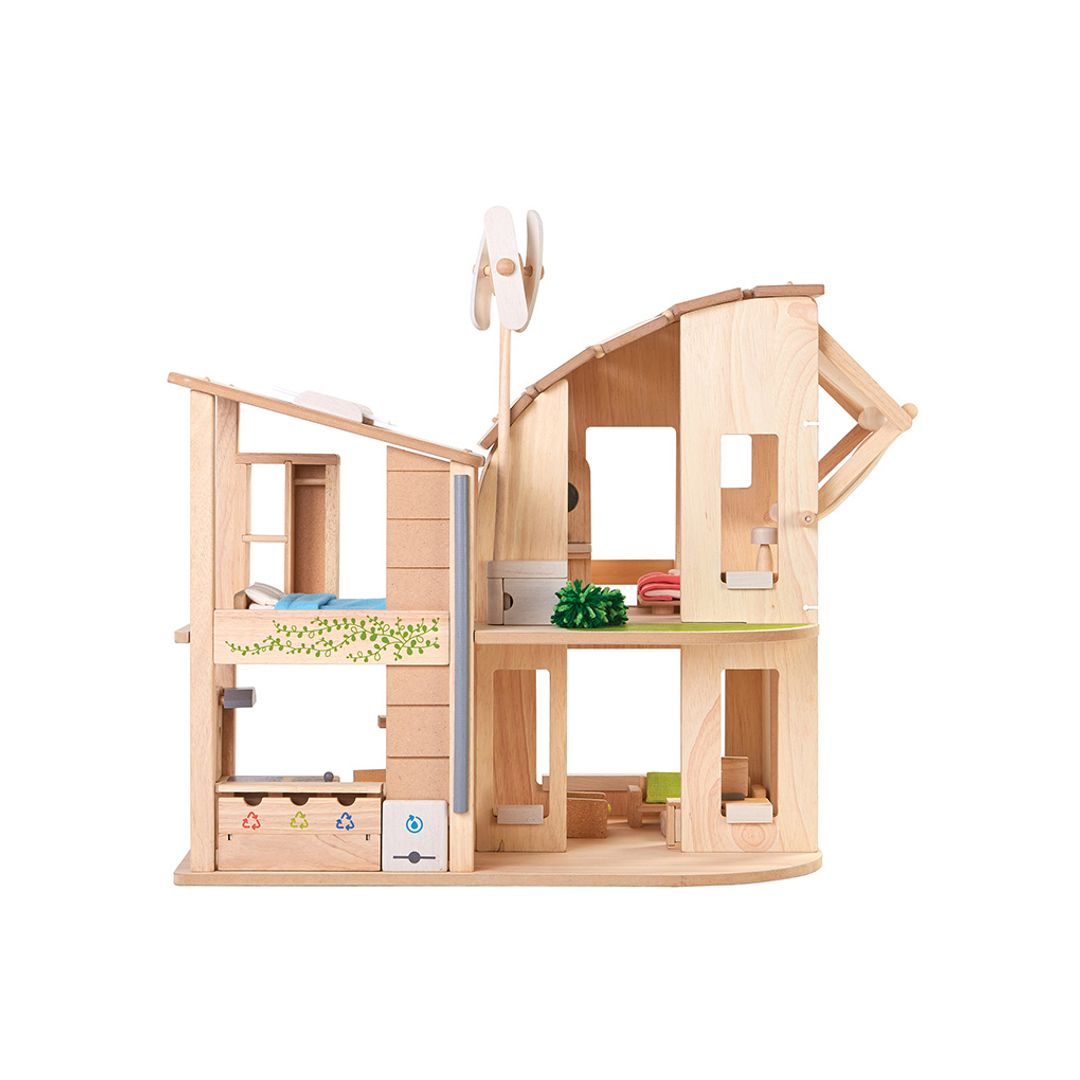 Anpther view of the  PlanToys Green Dollhouse with an eco-friendly design, featuring a wind turbine, solar panel, adjustable sunshade, and sustainable living elements.