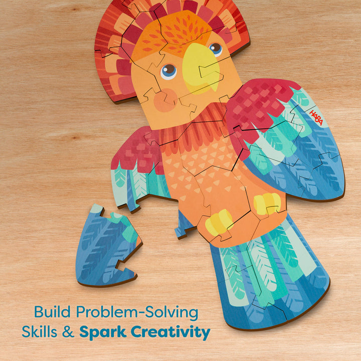 A parrot-shaped puzzle on a wooden surface with colorful feathers and text below reading "Build Problem-Solving Skills & Spark Creativity"