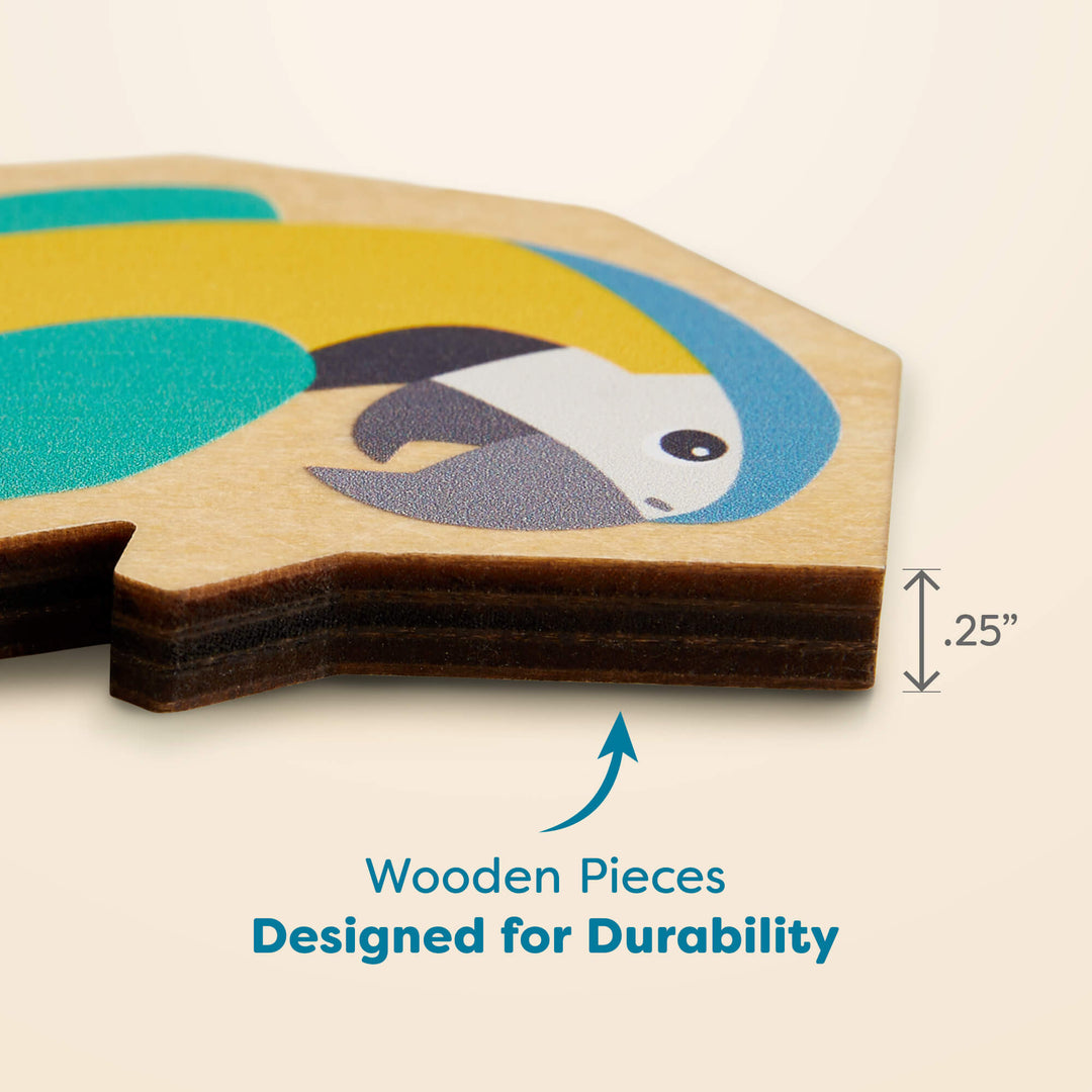 Close-up of a wooden puzzle piece featuring a parrot illustration, showing a labeled thickness of 0.25 inches. Text below reads "Wooden Pieces Designed for Durability"
