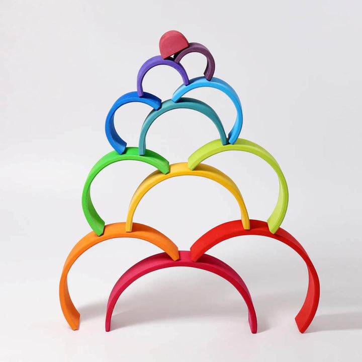 Stack of colorful wooden rings on a white background.