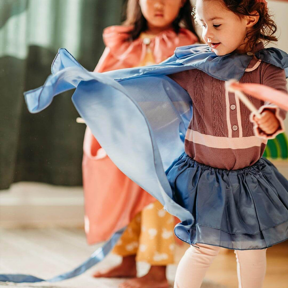 Child wearing Sarah's Silks Northern Playsilks cape and tutu in tidewater