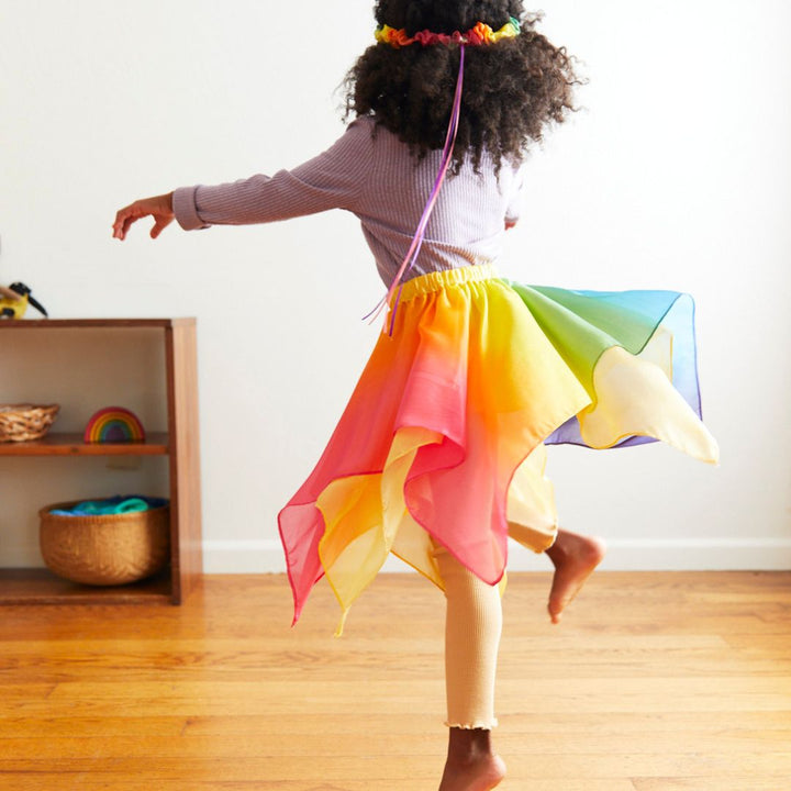 Child playing in Sarah's Silks skirt- Bella Luna Toys