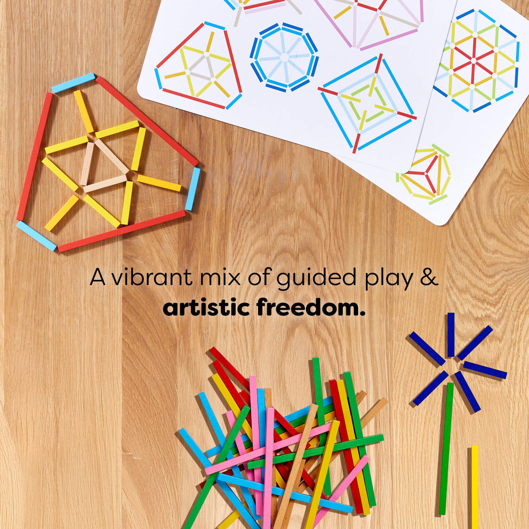 Colored sticks arranged in geometric patterns on a wooden surface with scattered sticks and a card with patterns.
Text reads "A vibrant mix of guided play & artistic freedom.