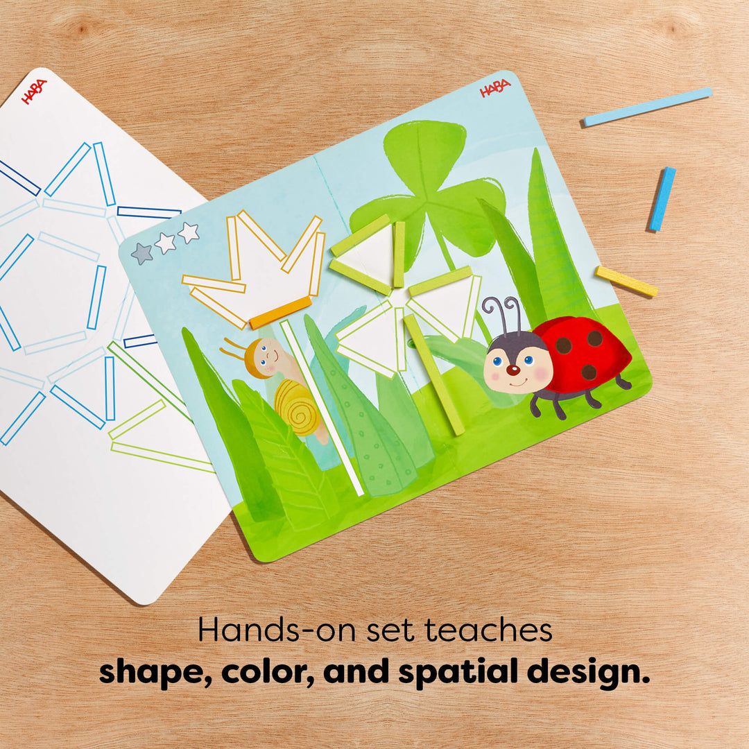 Wooden sticks on a template featuring geometric shapes and nature designs. text reads "Hands-on set teaches shape, color, and spatial design"
