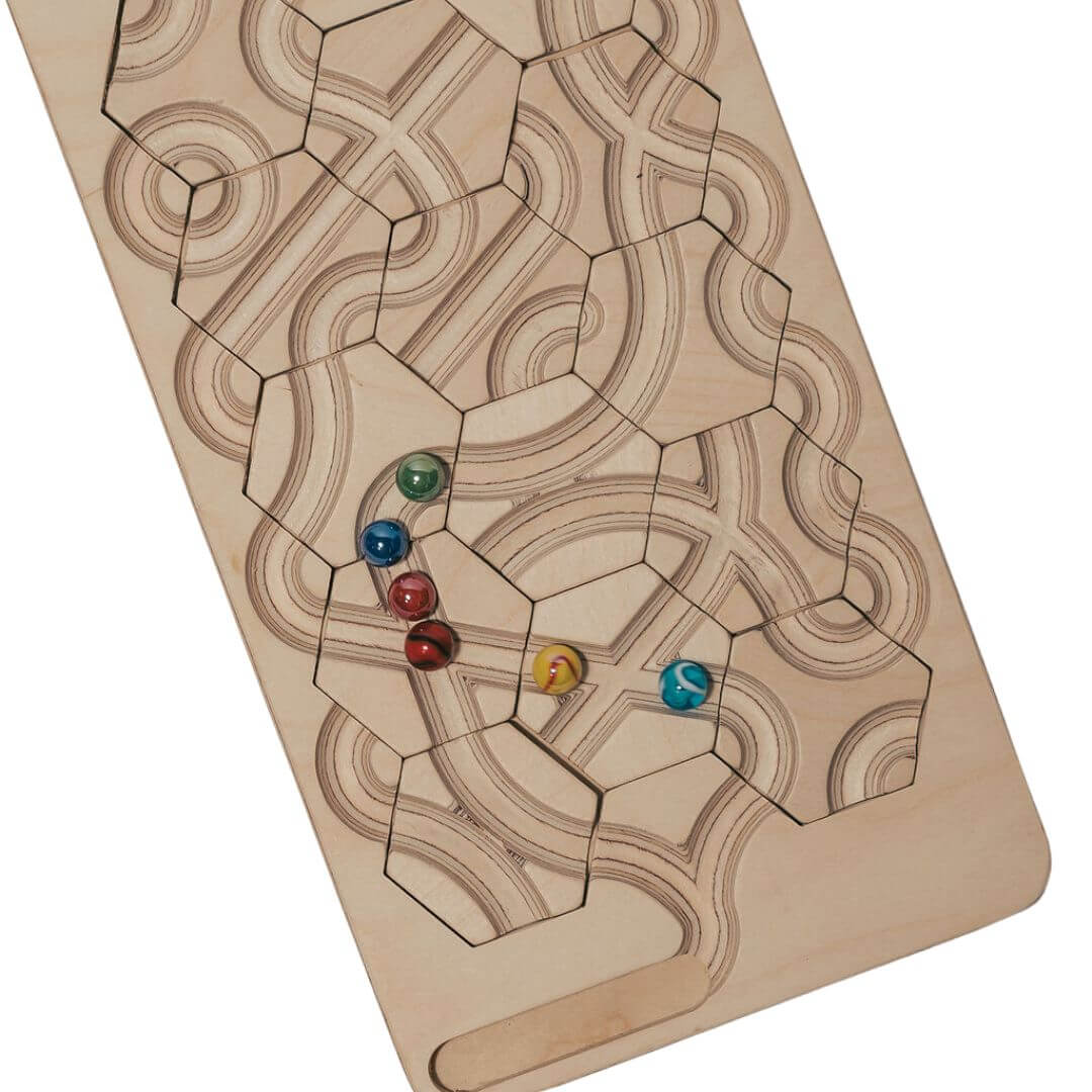 Close up of the wooden marble maze game board with rearrangeable hexagon tiles and colorful marbles, designed for puzzle-solving, marble racing, and open-ended track building - Bella Luna Toys