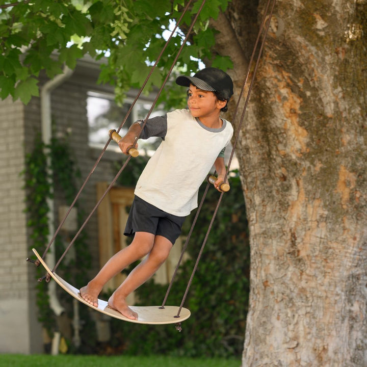 Swurfer-Child playing on wooden outdoor swing- Bella Luna Toys