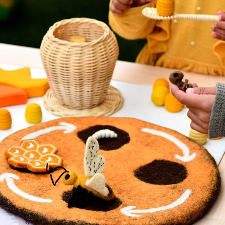 Child playing with Felted Honey Bee Life Stages Set with Playmat