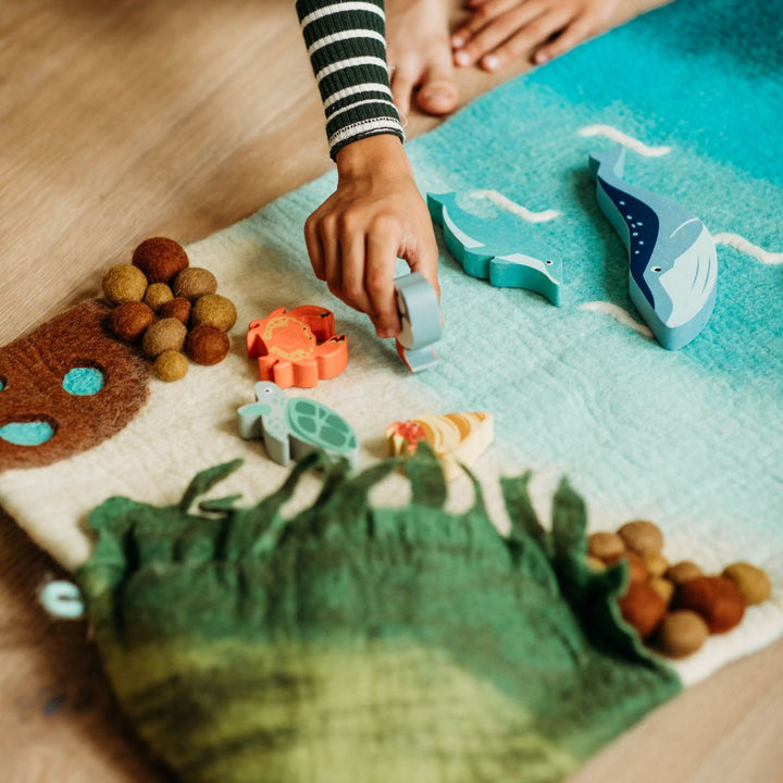 Tara Treasures Large Sea and Rockpool- Playmats-Child playing with ocean themed playmat- Bella Luna Toys